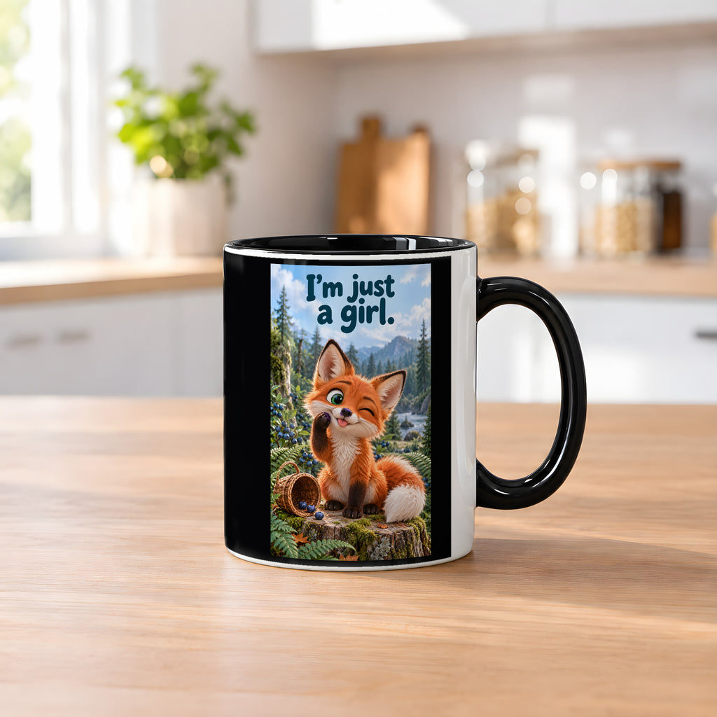 Ein kleiner Fuchs zwinkert mit herausgestreckter Zunge und einer Blaubeere an der Pfote neben einem umgekippten Beerenkorb. Spruch: I'm just a girl. – Tasse innen schwarz, Küchenansicht.