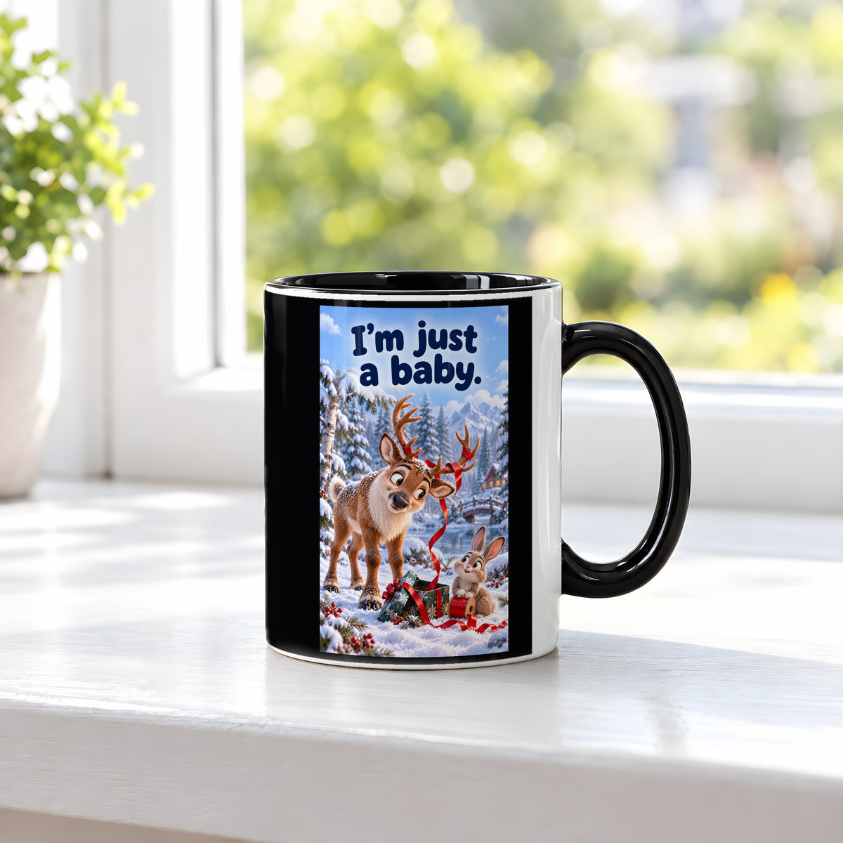 Ein Rentier mit rotem Geschenkband im Geweih blickt zu einem Kaninchen mit einer Bandrolle neben einem Geschenk im Schnee. Spruch: I'm just a baby. – Tasse innen schwarz, Ansicht am Fenster.