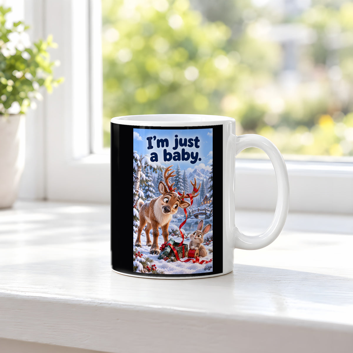 Ein Rentier mit rotem Geschenkband im Geweih blickt zu einem Kaninchen mit einer Bandrolle neben einem Geschenk im Schnee. Spruch: I'm just a baby. – weiße Tasse, Ansicht am Fenster.