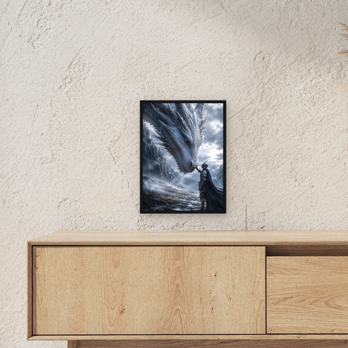 Ritter berührt die Schnauze des weißen Drachen, Dark Fantasy Wandbild gerahmt im schwarzen Holzrahmen ueber einem Sideboard, zeigt die Groesse im Raum
